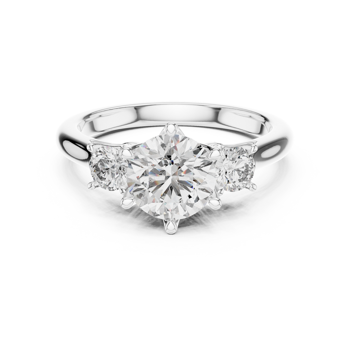 Diamond ring with three clear gemstones on a white background