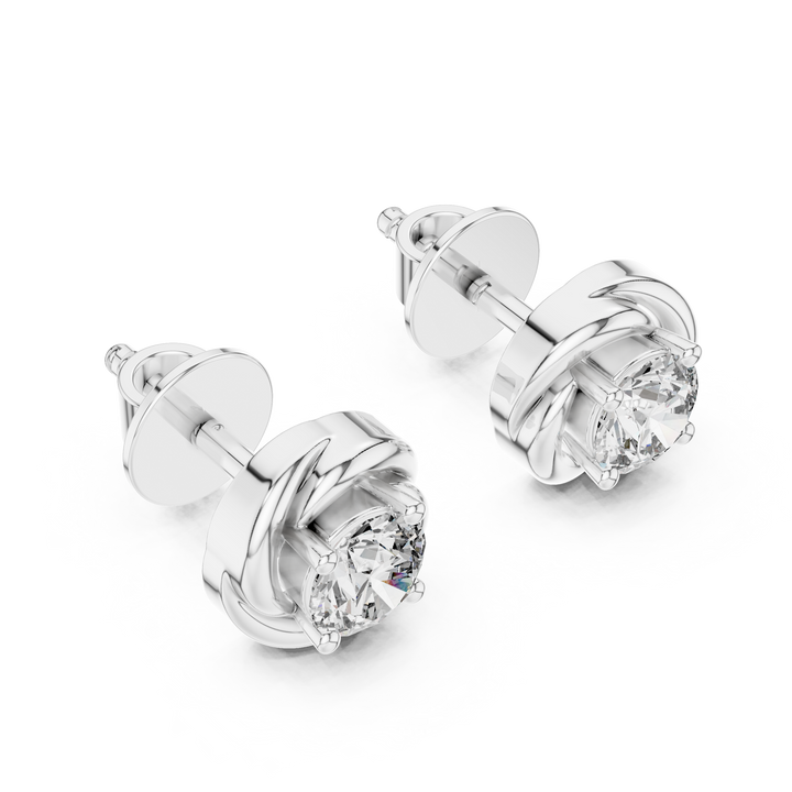 Pair of silver earrings with clear gemstones on a white background