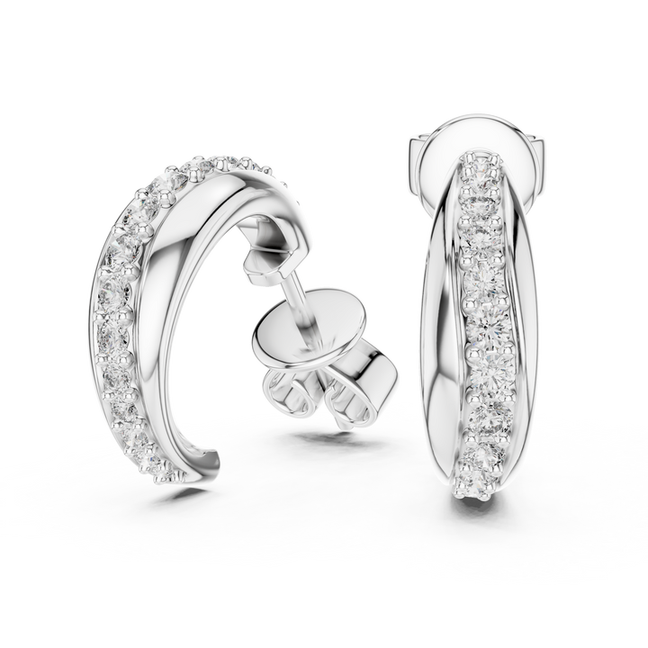 Pair of silver hoop earrings with clear gemstones on a white background