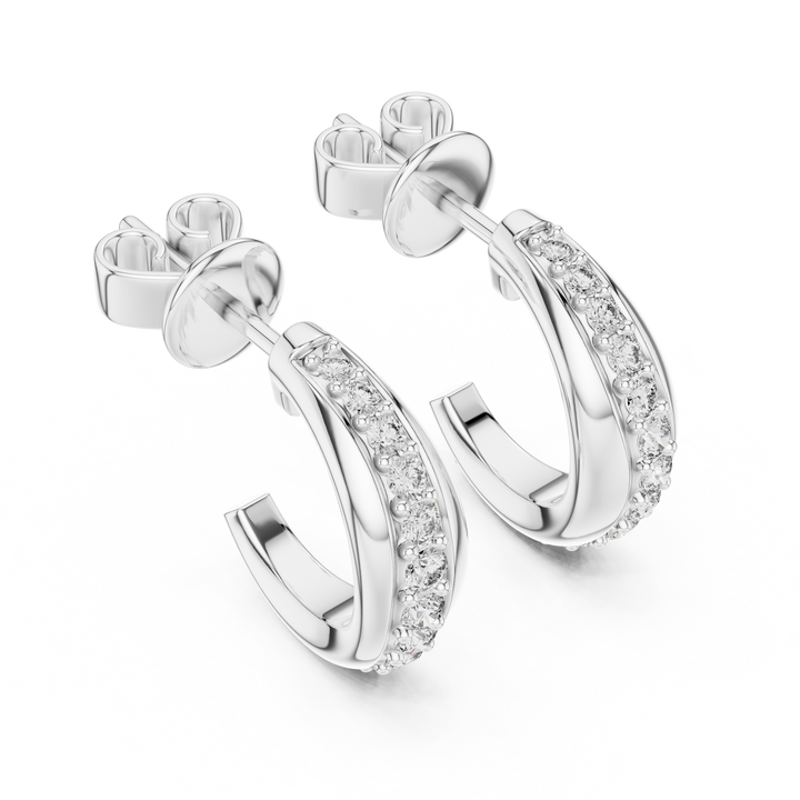 Silver hoop earrings with clear gemstones on a white background