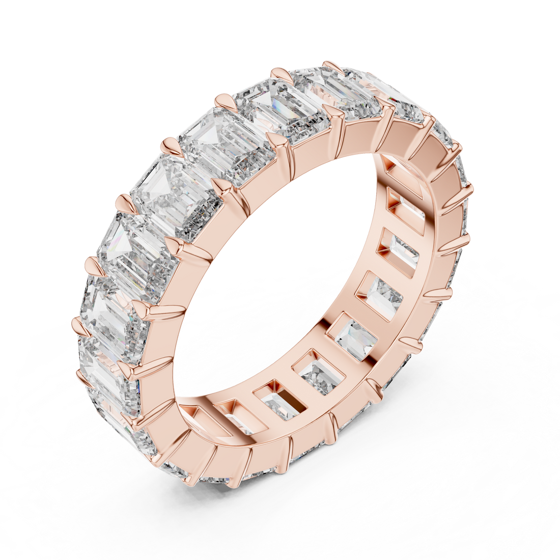 Rose gold ring with emerald-cut diamonds on a white background