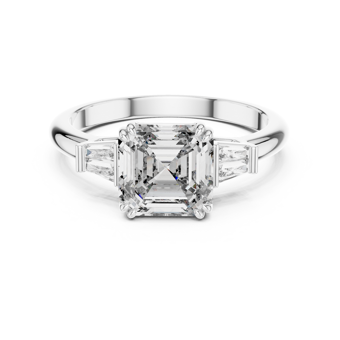 Diamond ring with a central emerald-cut diamond and baguette side stones on a white background