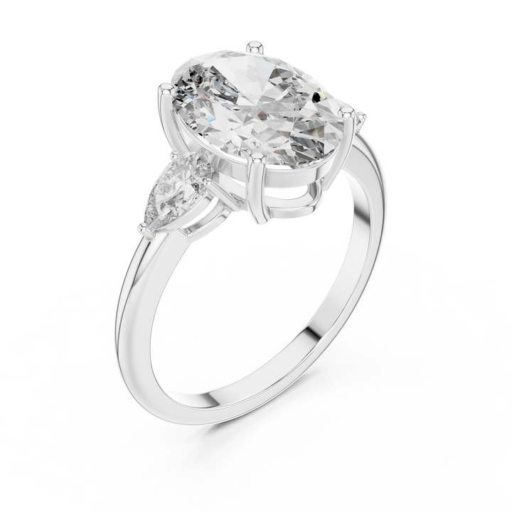 Diamond ring with a pear-shaped center stone on a white background