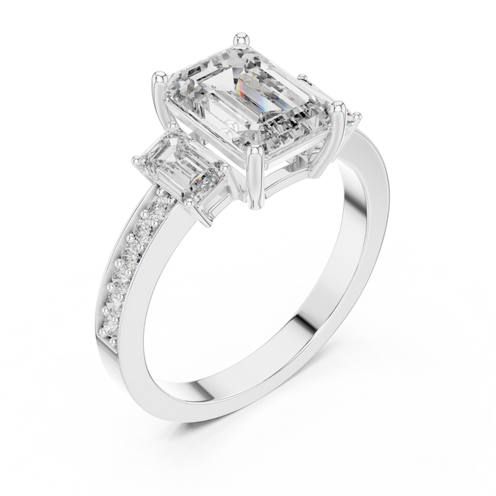 Diamond ring with emerald-cut and baguette-cut diamonds on a white background