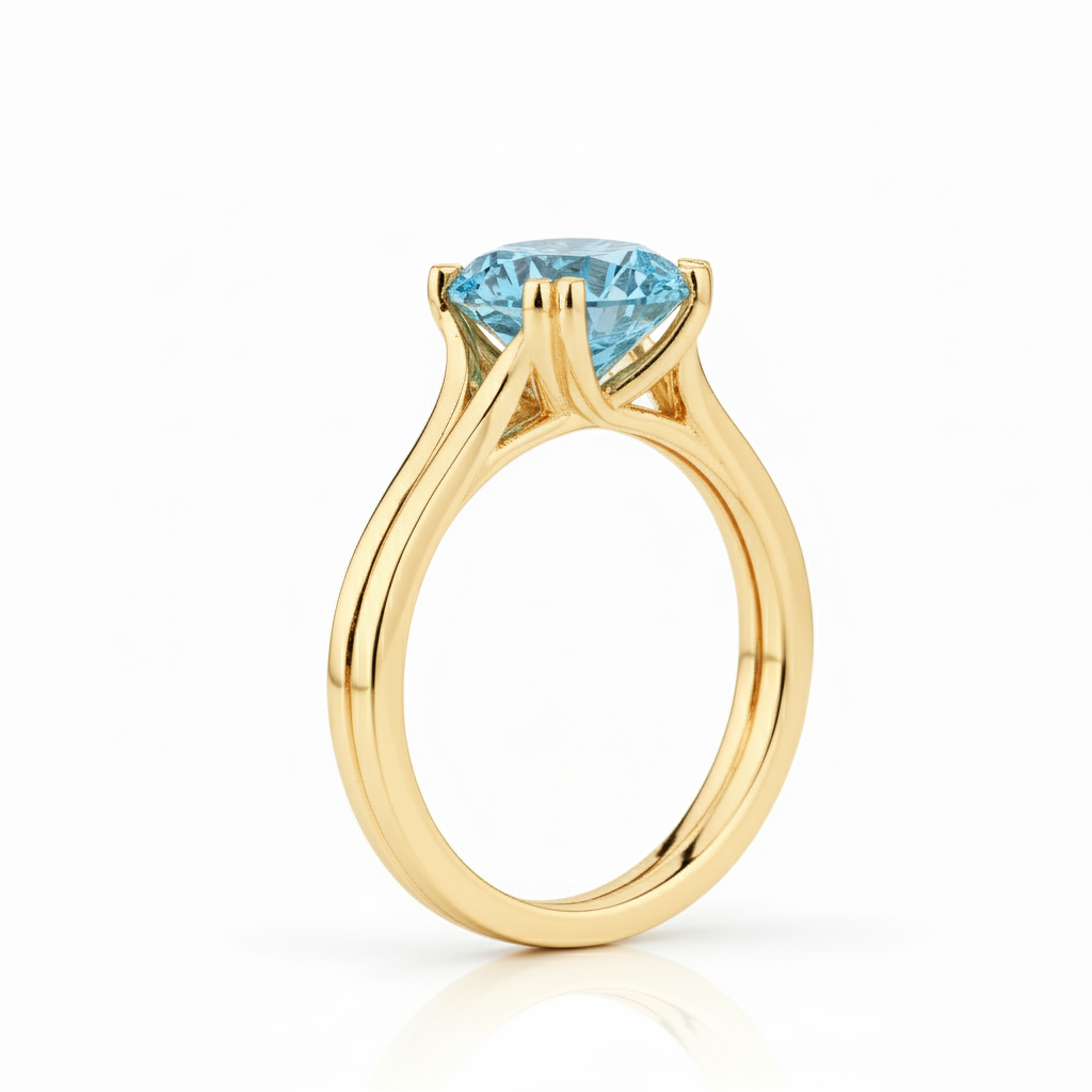 Gold ring with a blue gemstone on a white background