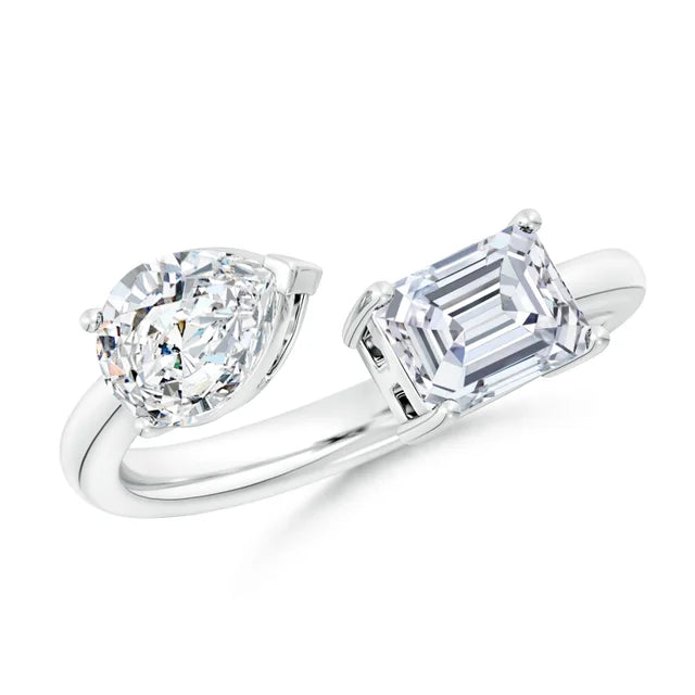 Diamond ring with heart-shaped and emerald-cut diamonds on a white background