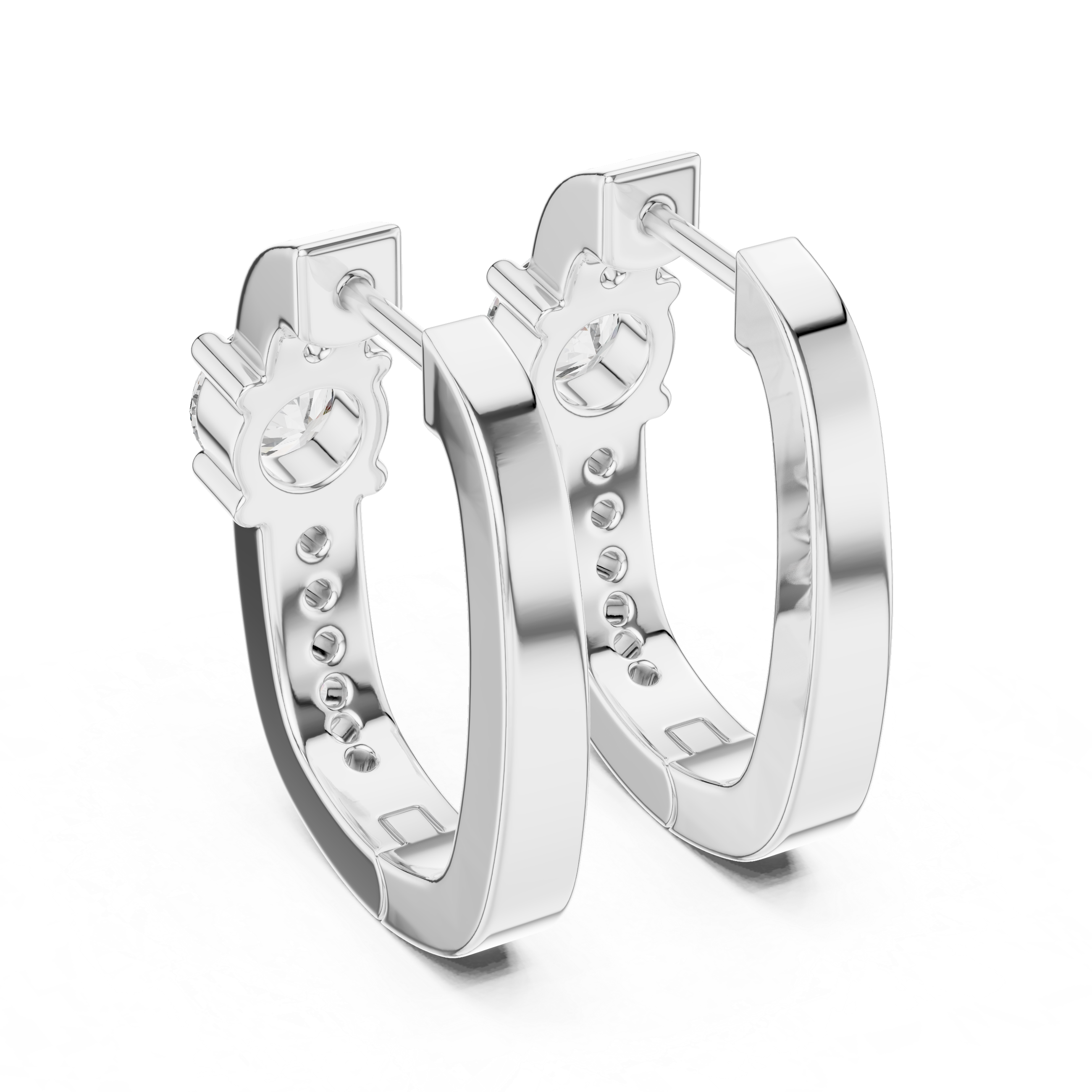 Silver hoop earrings with intricate designs on a white background