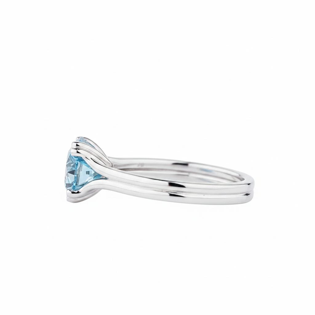 Silver ring with a blue gemstone on a white background