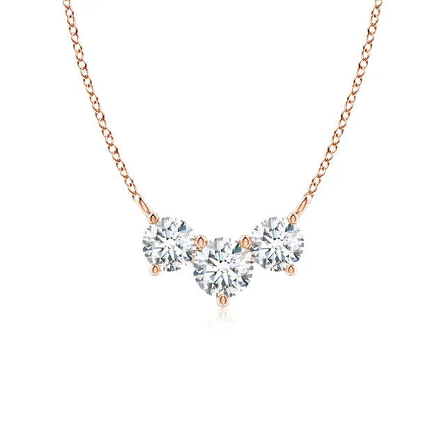 Heart-shaped diamond necklace with rose gold chain on a white background