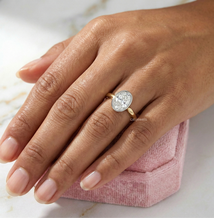 Two Tone Oval Cut Lab Grown Diamond Bezel Set Engagement Ring