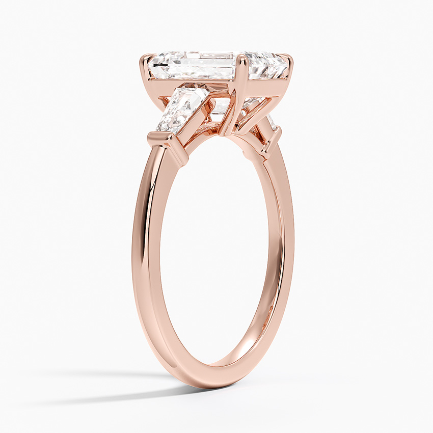 Rose gold ring with diamond accents on a white background