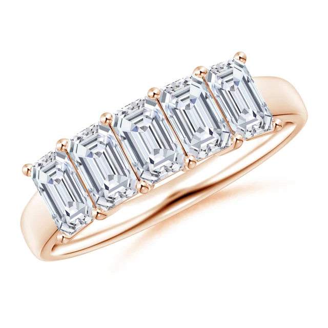 Rose gold ring with emerald-cut diamonds on a white background