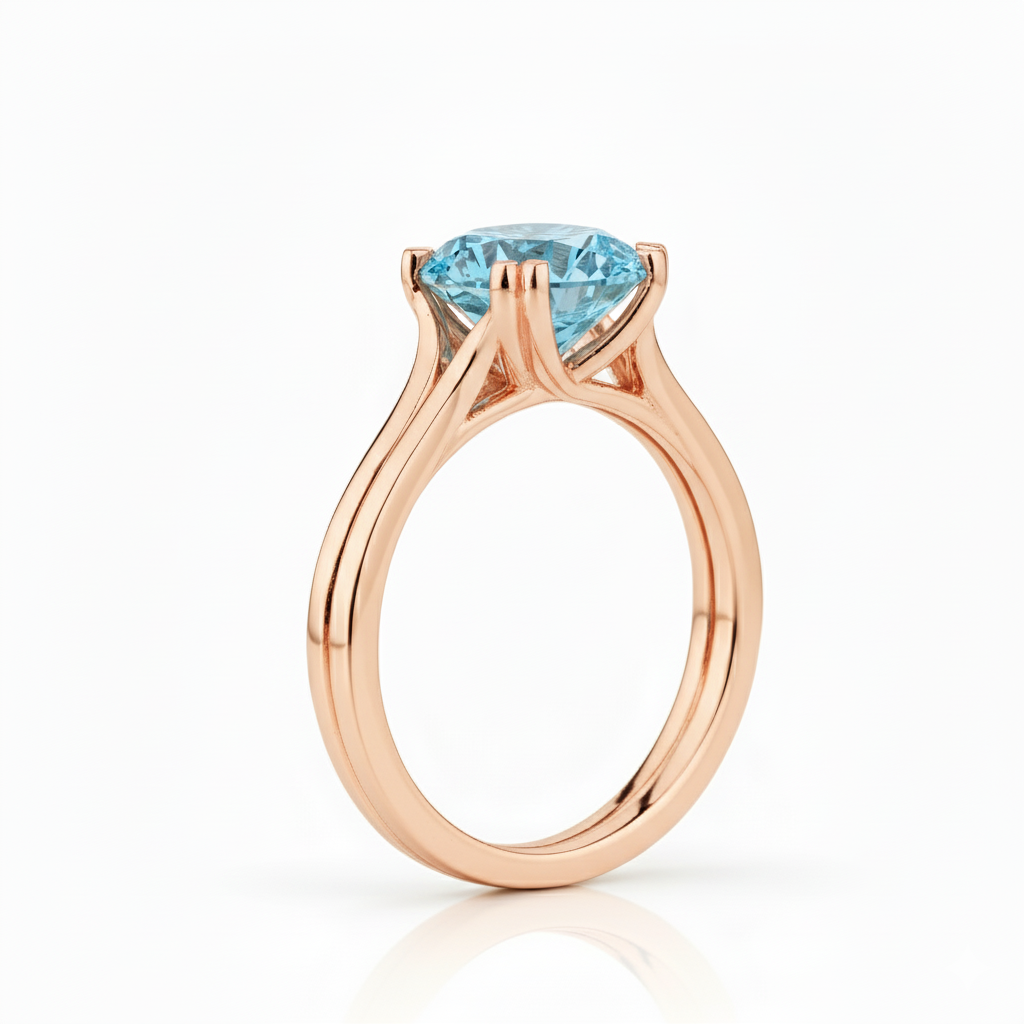 Rose gold ring with a blue gemstone on a white background