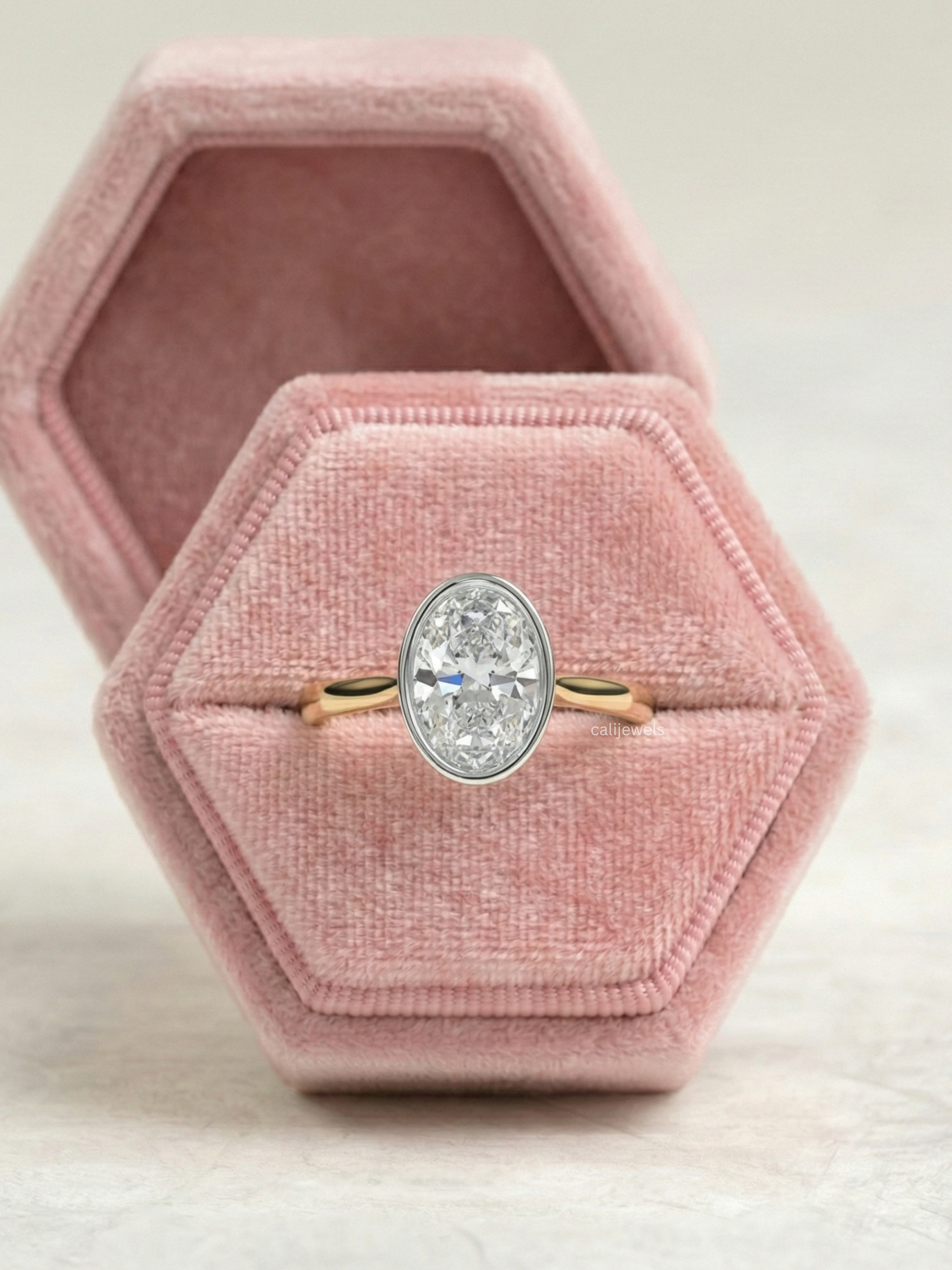 Two Tone Oval Cut Lab Grown Diamond Bezel Set Engagement Ring