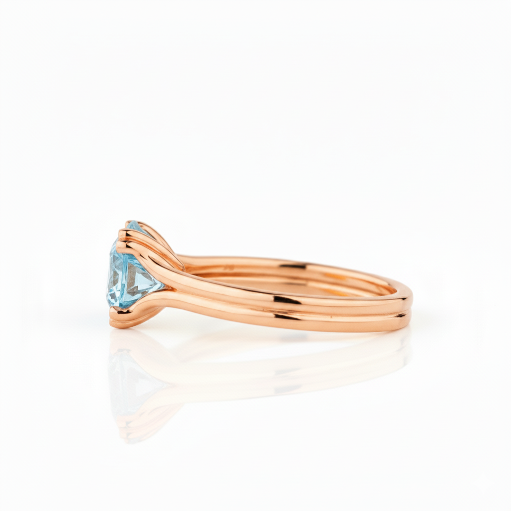 Rose gold ring with a blue gemstone on a white background