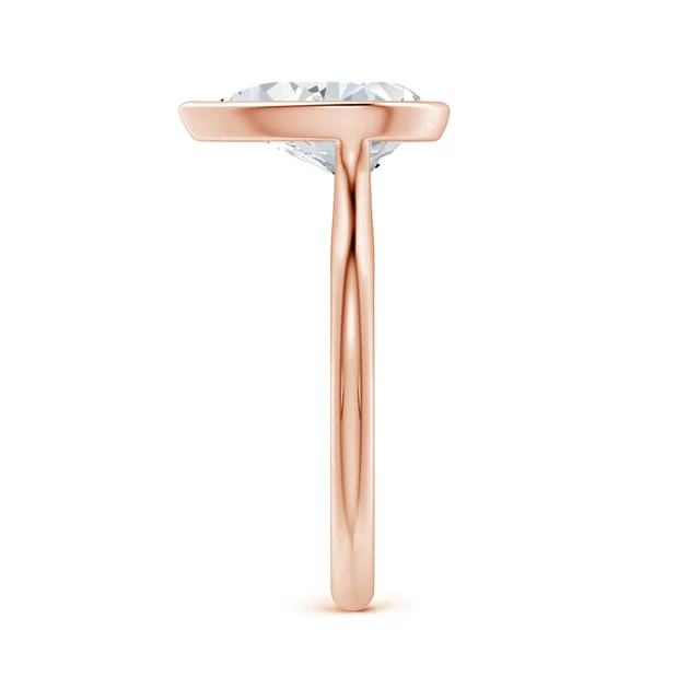 Rose gold ring with a clear gemstone on a white background