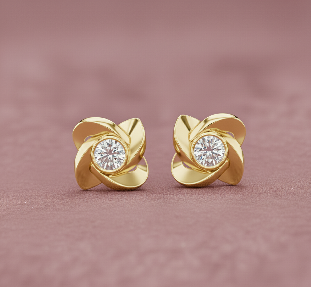 Gold earrings with diamond centers on a pink background