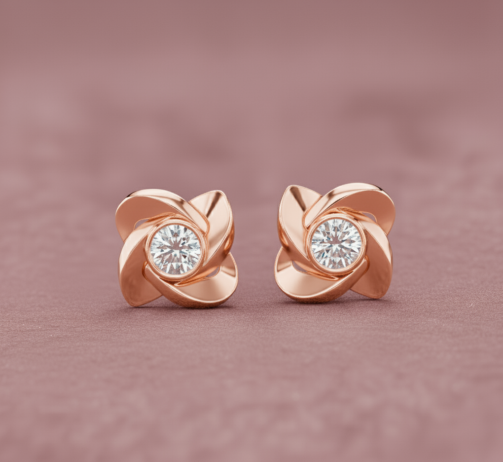 Rose gold earrings with diamond centers on a pink background