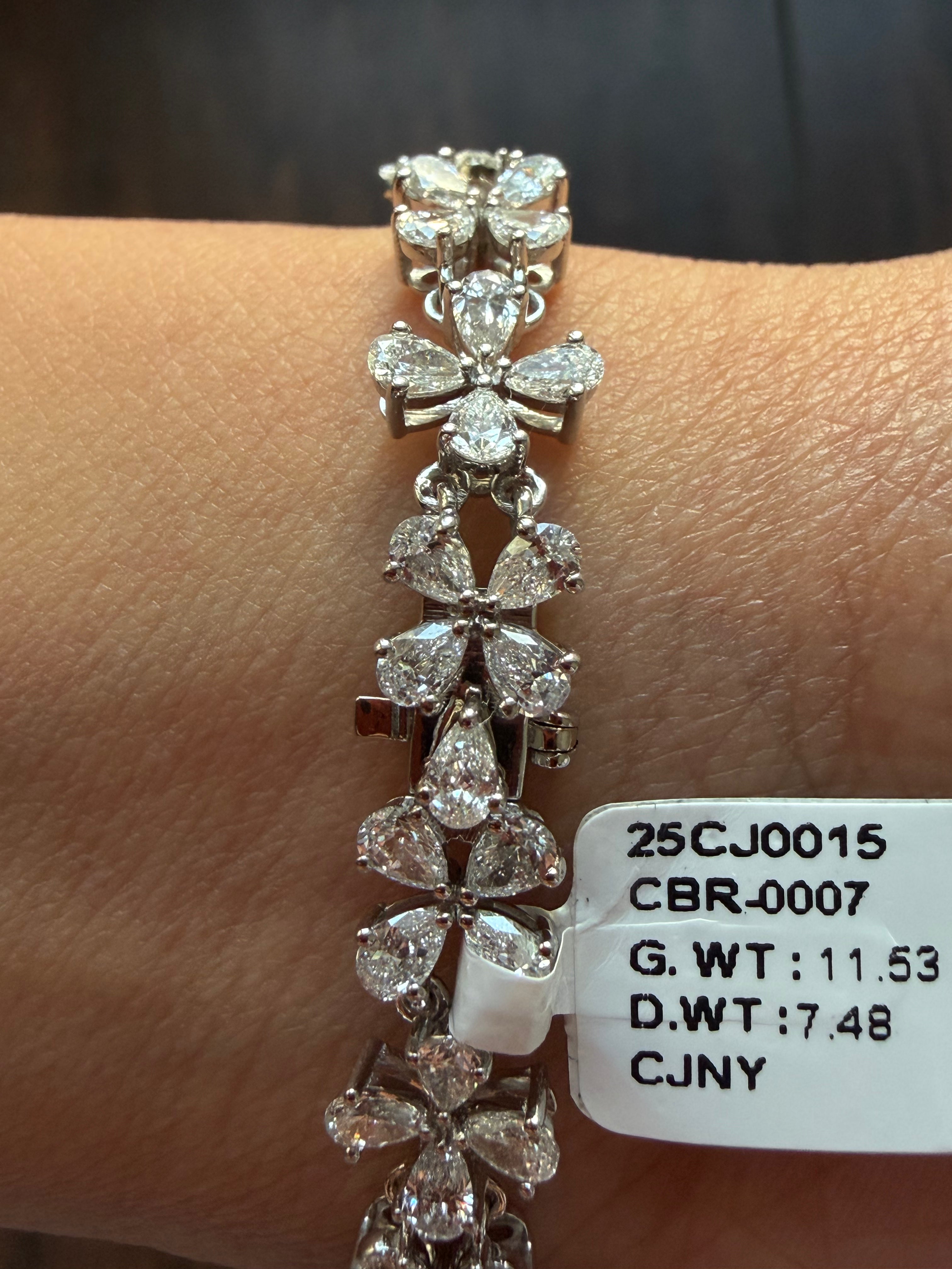Diamond bracelet on a wrist with weight and measurement details visible