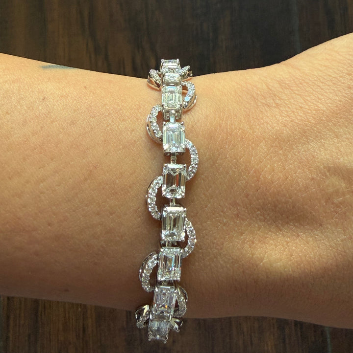 Diamond bracelet on a wrist with a wooden background