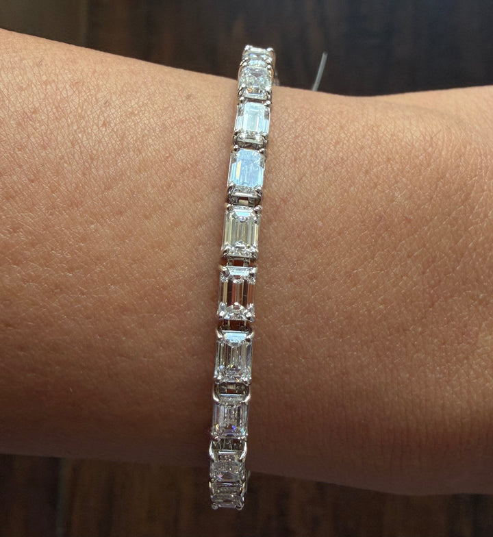 Diamond bracelet on a wrist against a neutral background
