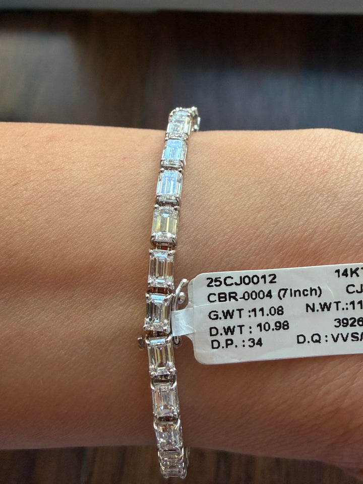 Diamond bracelet on a wrist with a label displaying jewelry details.