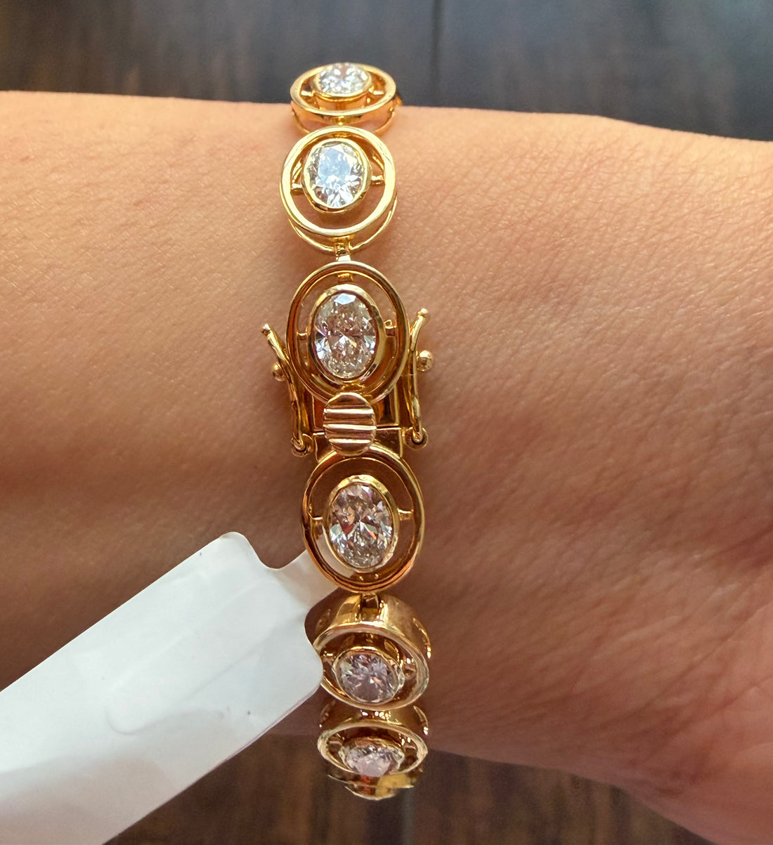 Gold bracelet with diamond accents on a wrist