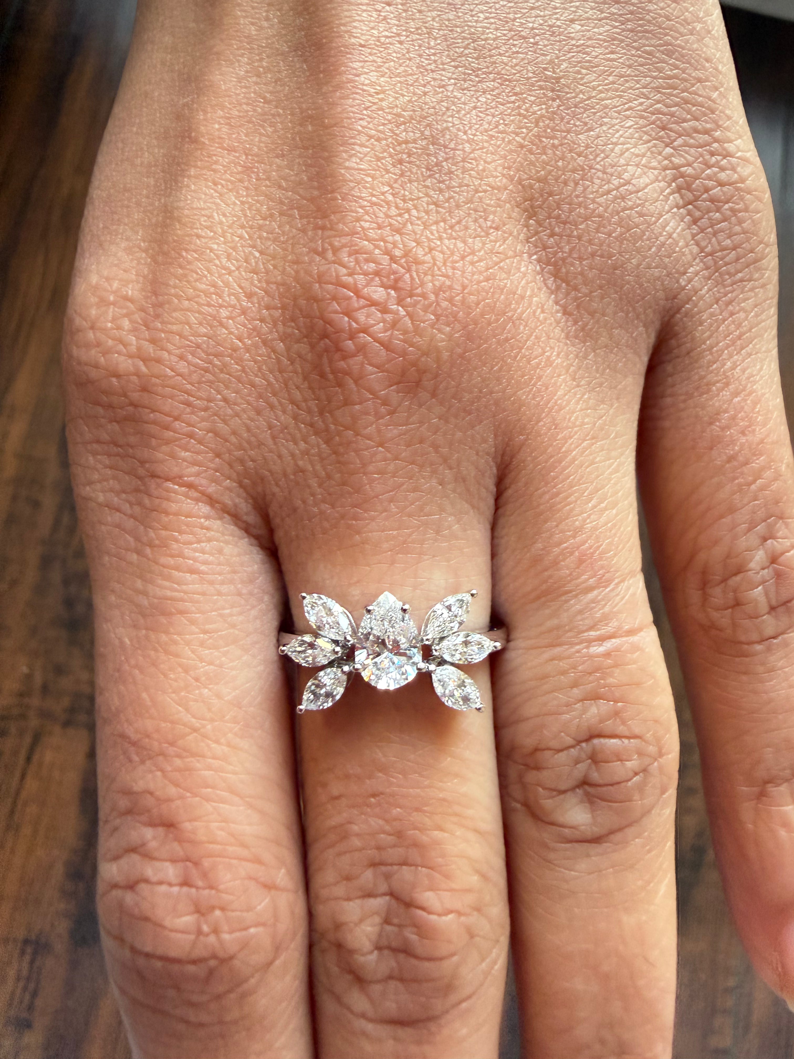 Diamond ring on a finger with a wooden surface background