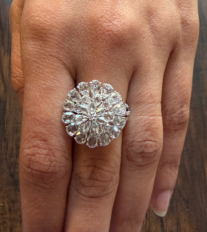 Diamond ring on a finger with a wooden background