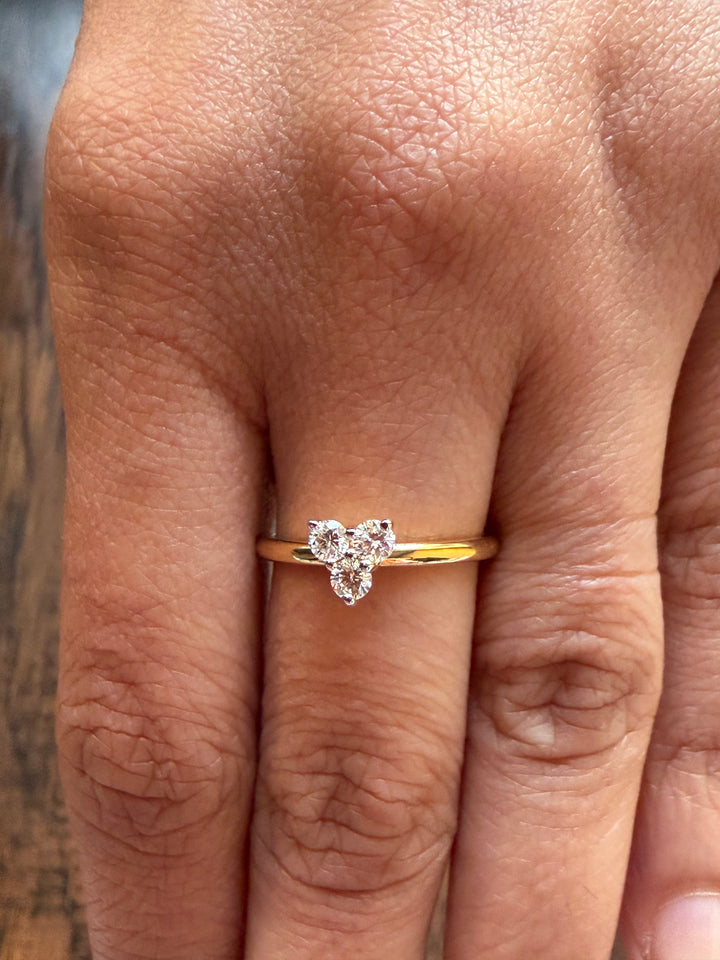 Gold ring with a diamond on a person's finger