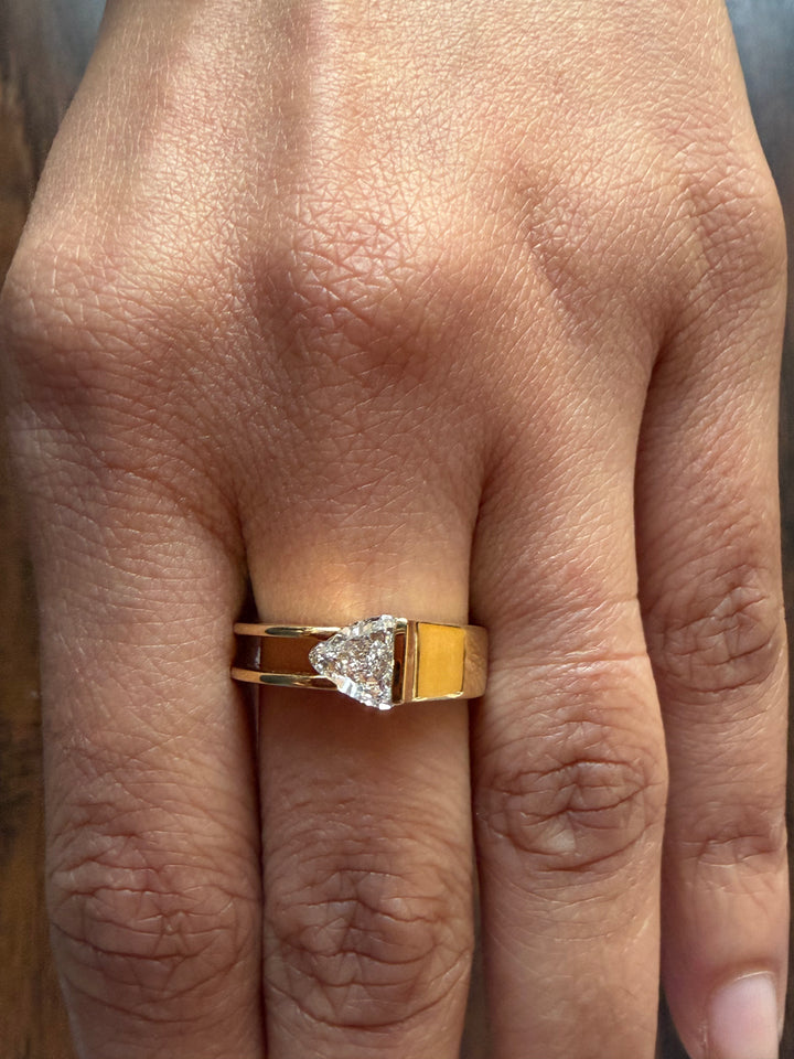 Gold ring with a diamond on a person's finger