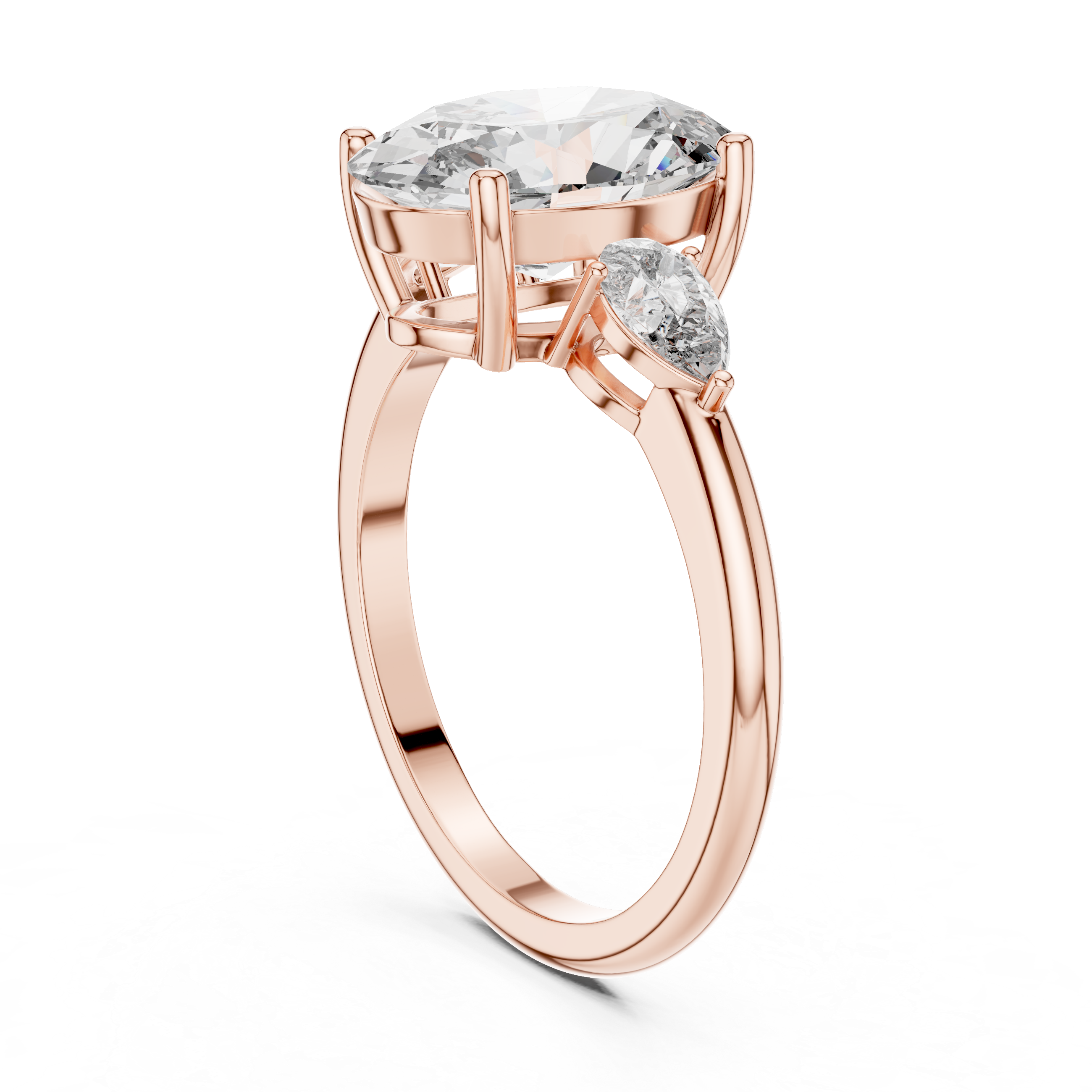 Rose gold ring with a large diamond and smaller pear-shaped diamond on a white background